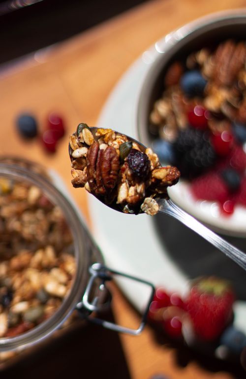 Free Close-up of spoonful of granola with fresh berries and nuts, perfect for a healthy breakfast. Stock Photo