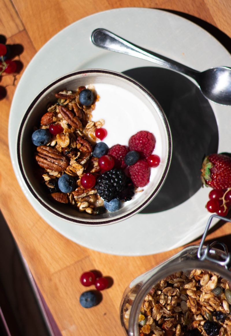 Bowl of oatmeal topped with berries and nuts