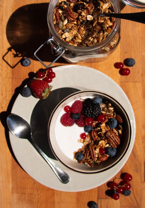 Free Top view of a healthy breakfast bowl with granola, assorted berries, and yogurt. Stock Photo