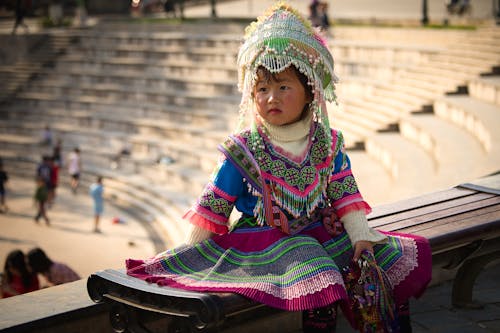 A Child Wearing Colorful Traditional Clothes
