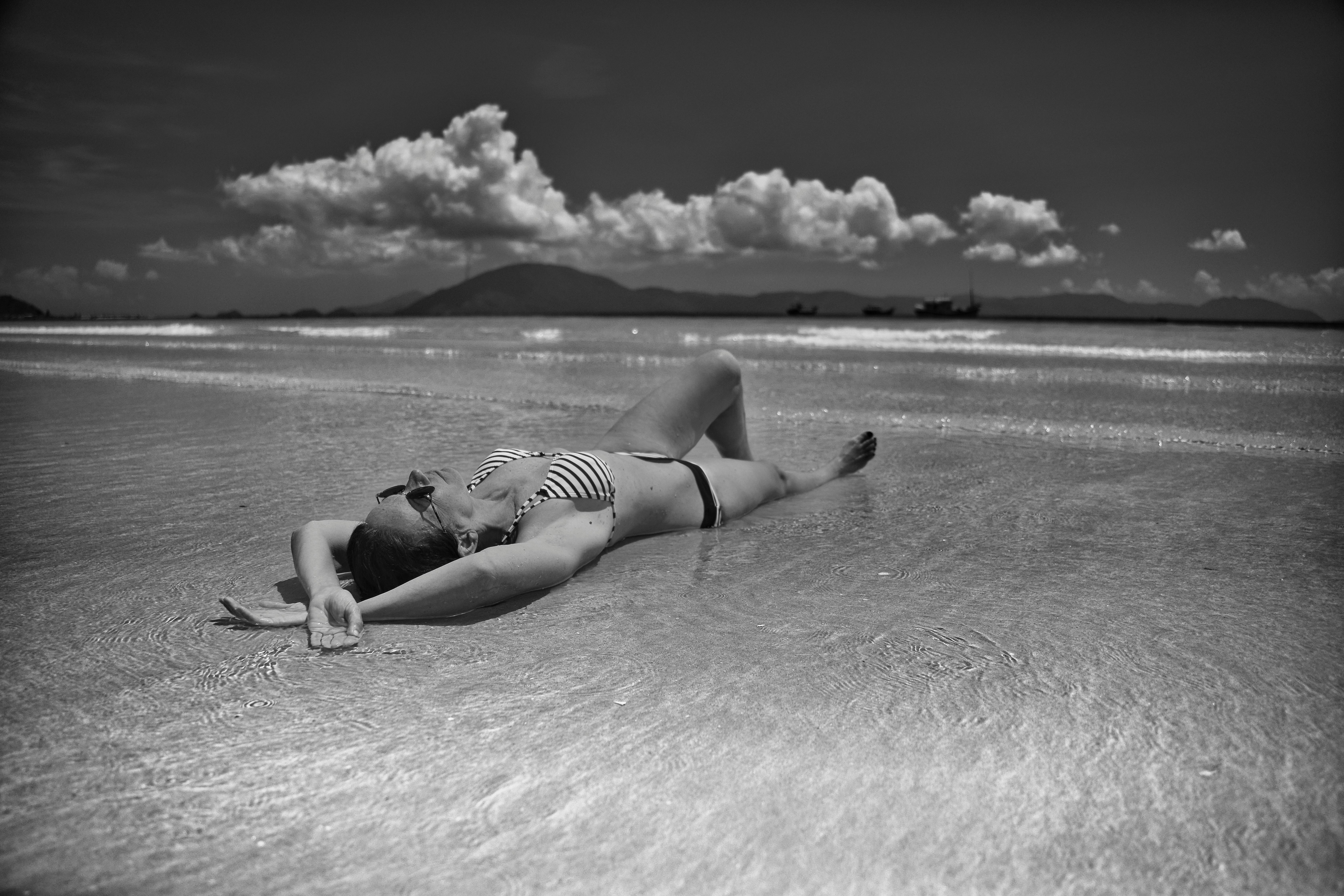 A woman in a bikini enjoys the tranquility of Ninh Hòa's beach.