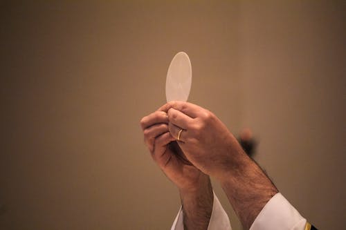 A Man Holding a Communion Host