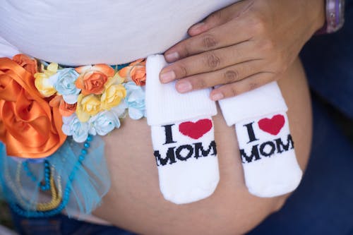 Free I Love Mom Socks on a Mother's Baby Bump Stock Photo