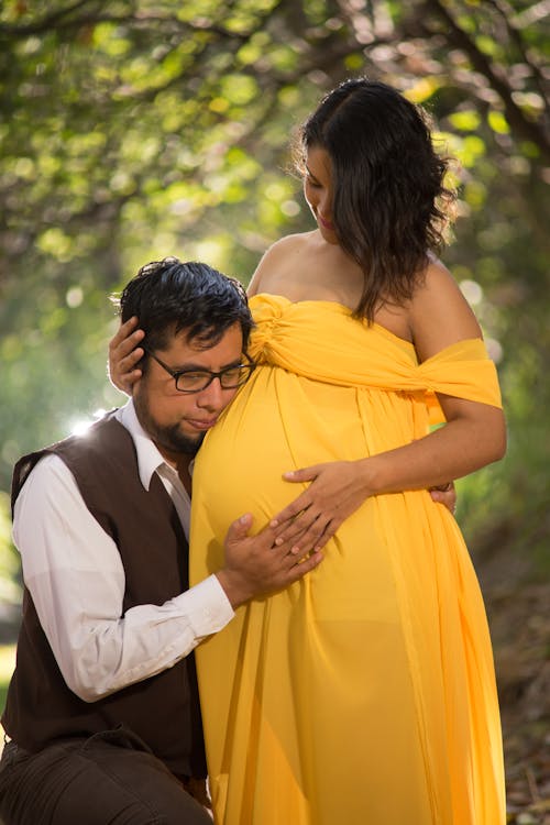 Free Man Hugging a Pregnant Woman Stock Photo