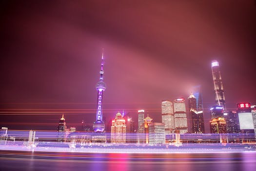 Dazzling night view of Shanghai's skyline featuring the Oriental Pearl Tower and luminous skyscrapers.