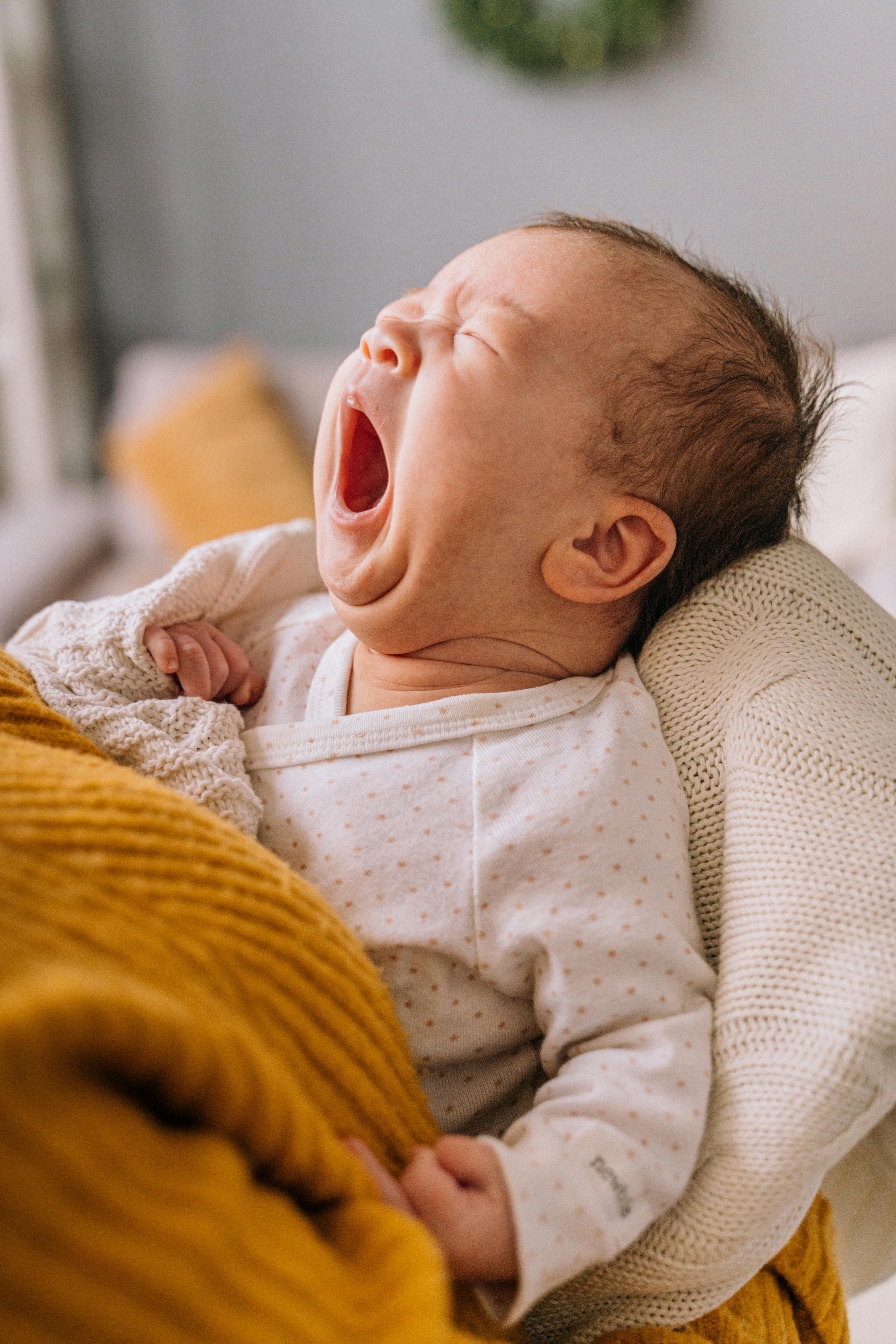 baby in a blanket yawning