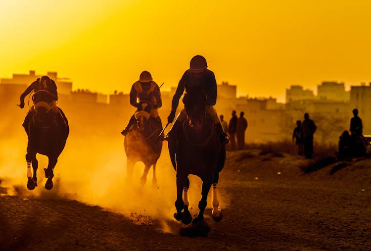 Silhouette Of 2 Men Riding Horses During Sunset