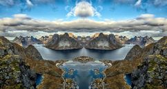 Body of Water Near Mountain Under Blue Sky