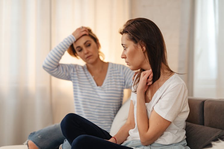 Worried Woman Sitting On A Sofa 