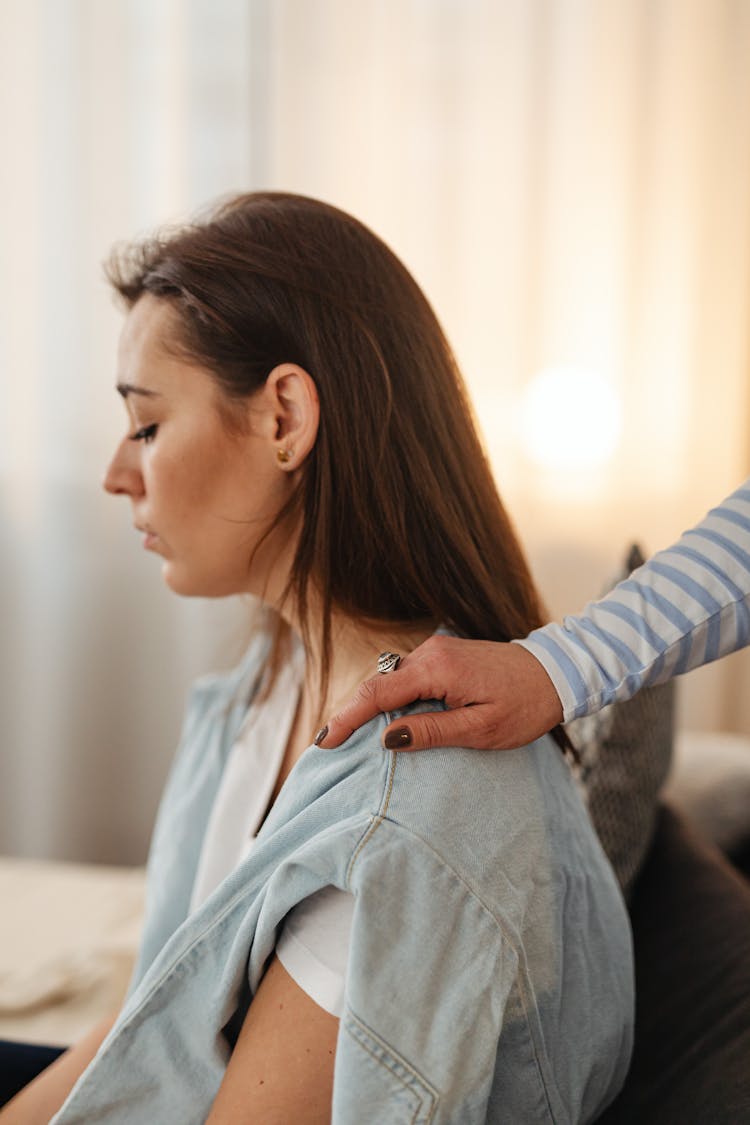 A Person Tapping A Woman's Shoulder