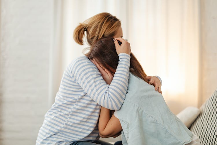 Mother Comforting Crying Daughter