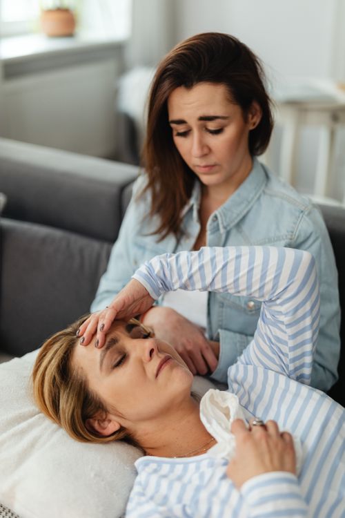 Free Two women indoors, one comforting the other experiencing stress and emotion. Stock Photo