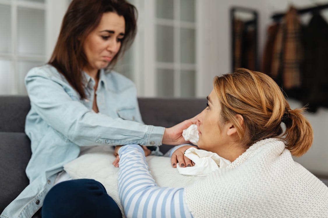 Photo of a Woman Wiping the Tears of a Crying Woman