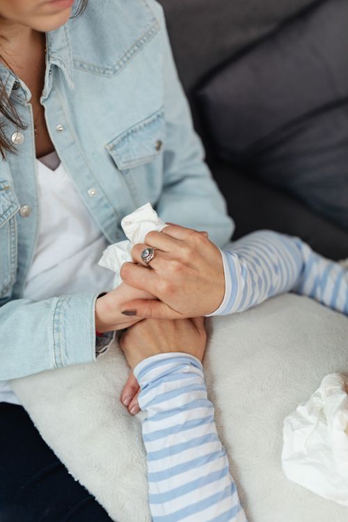 Free Close-up of two people holding hands, symbolizing support and care at home. Stock Photo