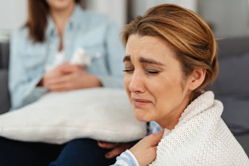 A Crying Woman in White Knitted Sweater 