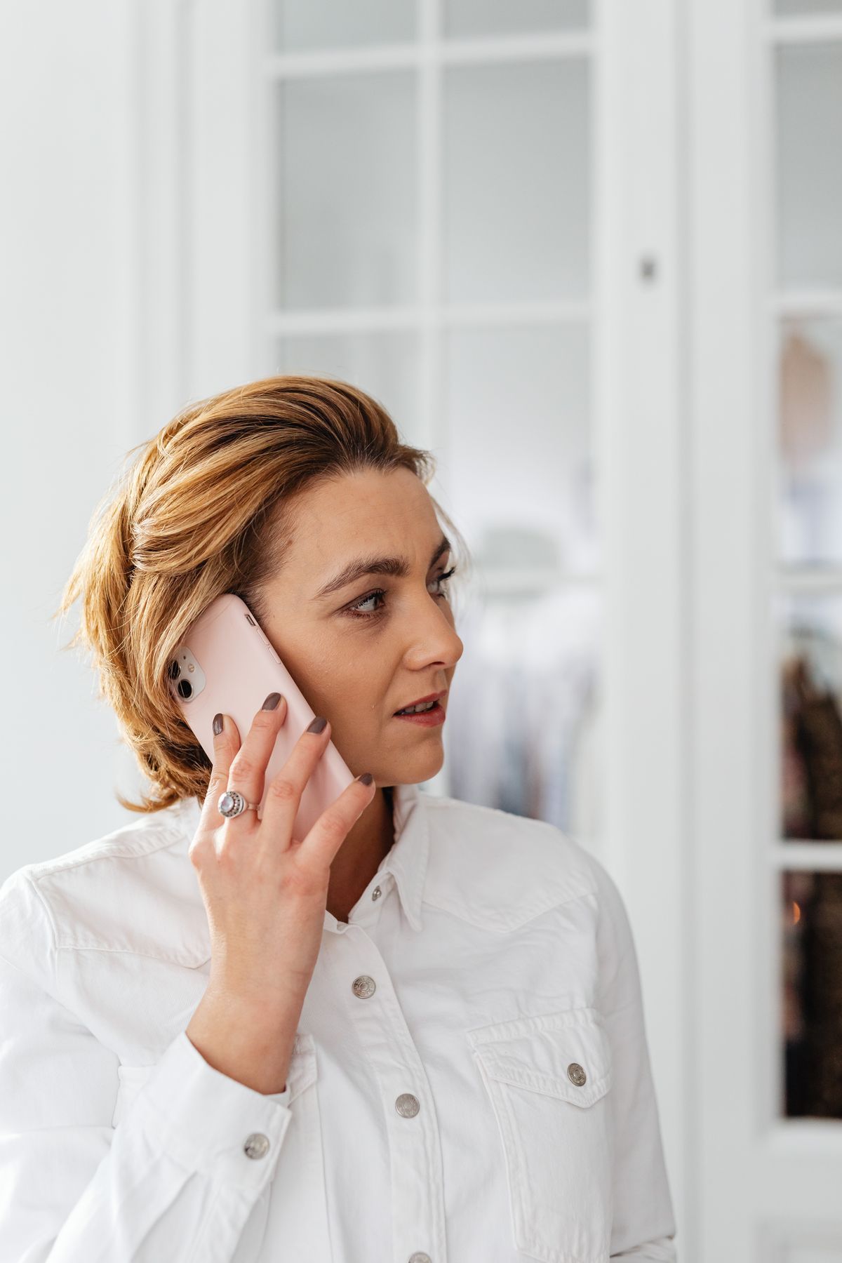 Woman calling her doctor's office on her phone from home