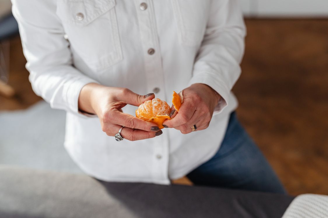 Close-Up Shot of a Person Peeling an Orange · Free Stock Photo