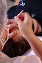 Photo of a Person Plucking a Woman's Eyebrows