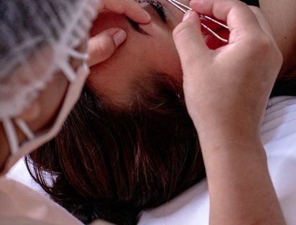 Brow shaping session with precision tools