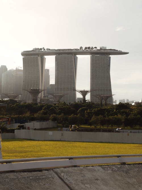 Exterior of famous creative Marina Bay Sands hotel located near lush Botanic Gardens on clear sunny day in Singapore