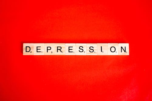 Word "Depression" Composed of Tiles with Letters on Red Background 