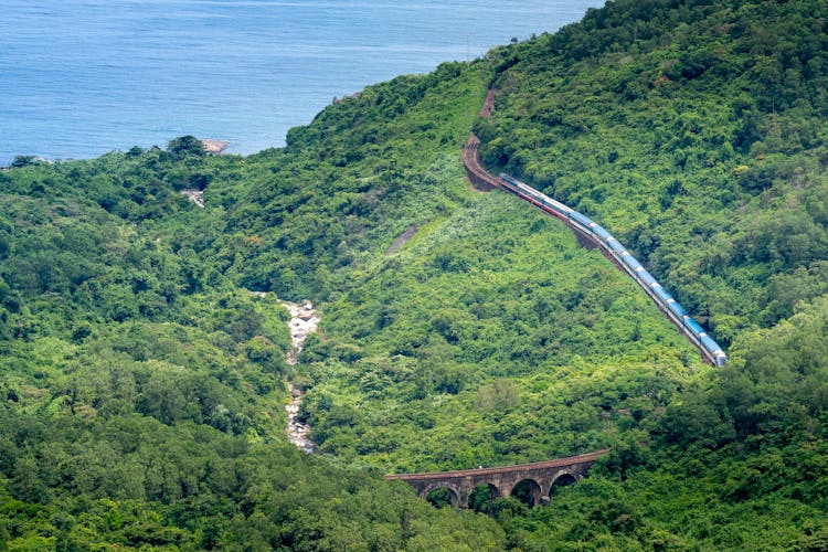 Train Driving On Railway In Green Mountains