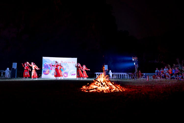 Anonymous Dancers On Stage Near Burning Bonfire During Traditional Local Fire Festival