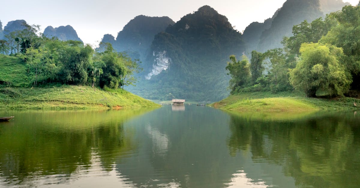 Tranquil landscape of Vietnam's limestone mountains and serene lake.