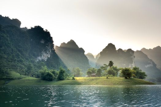 Scenic landscape of rocky cliffs surrounding lake at sunset