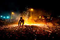 Kids jumping on burning sparks at night