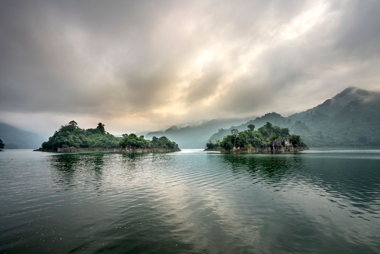 picturesque scenery of rocky cliffs in rippling water of pond against