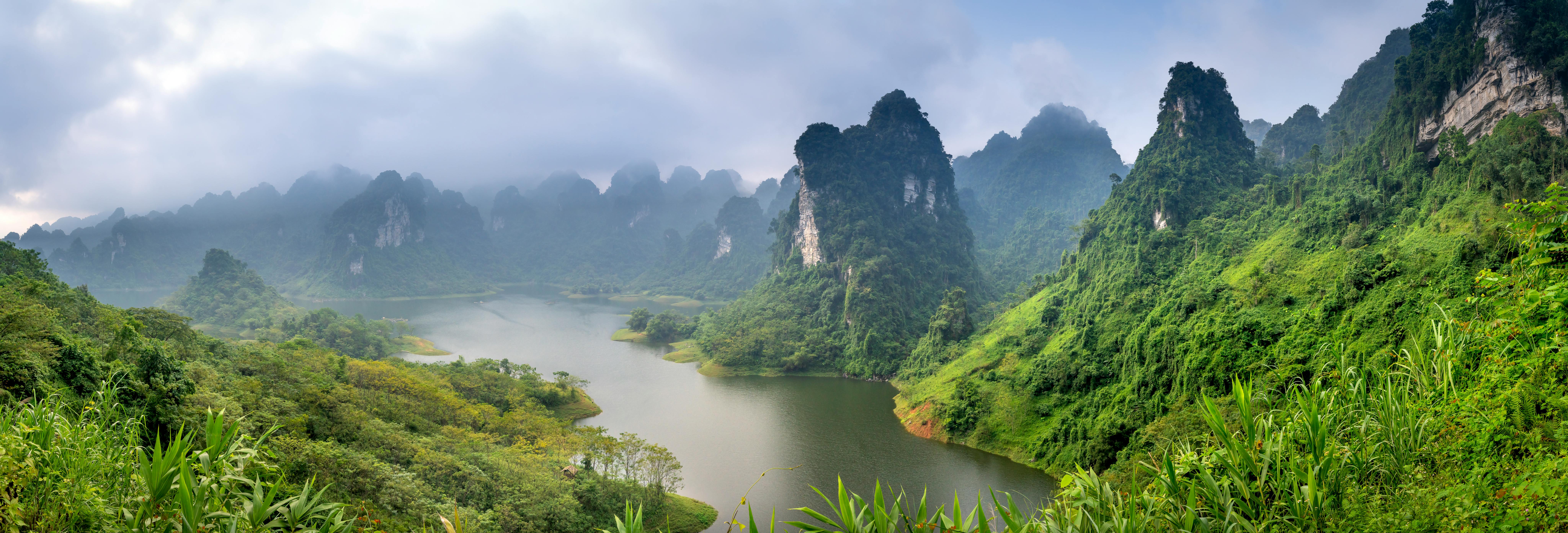 Scenic coastal cliff with luxury eco resorts overlooking turquoise ocean waters at sunrise