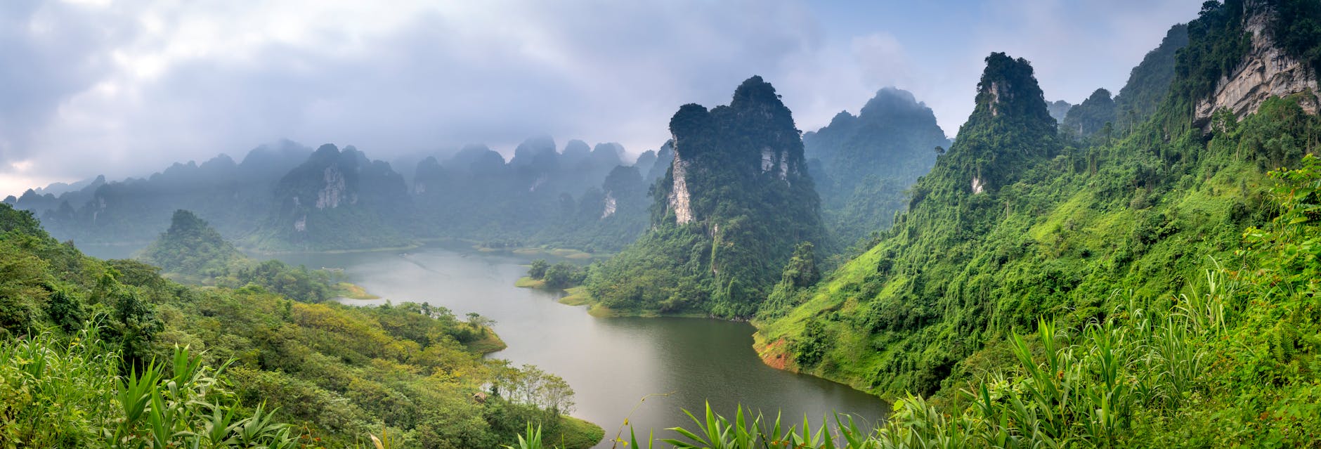 Scenic coastal cliff with luxury eco resorts overlooking turquoise ocean waters at sunrise