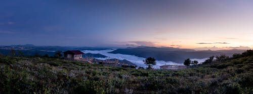 Typical houses in mountainous countryside under sundown sky