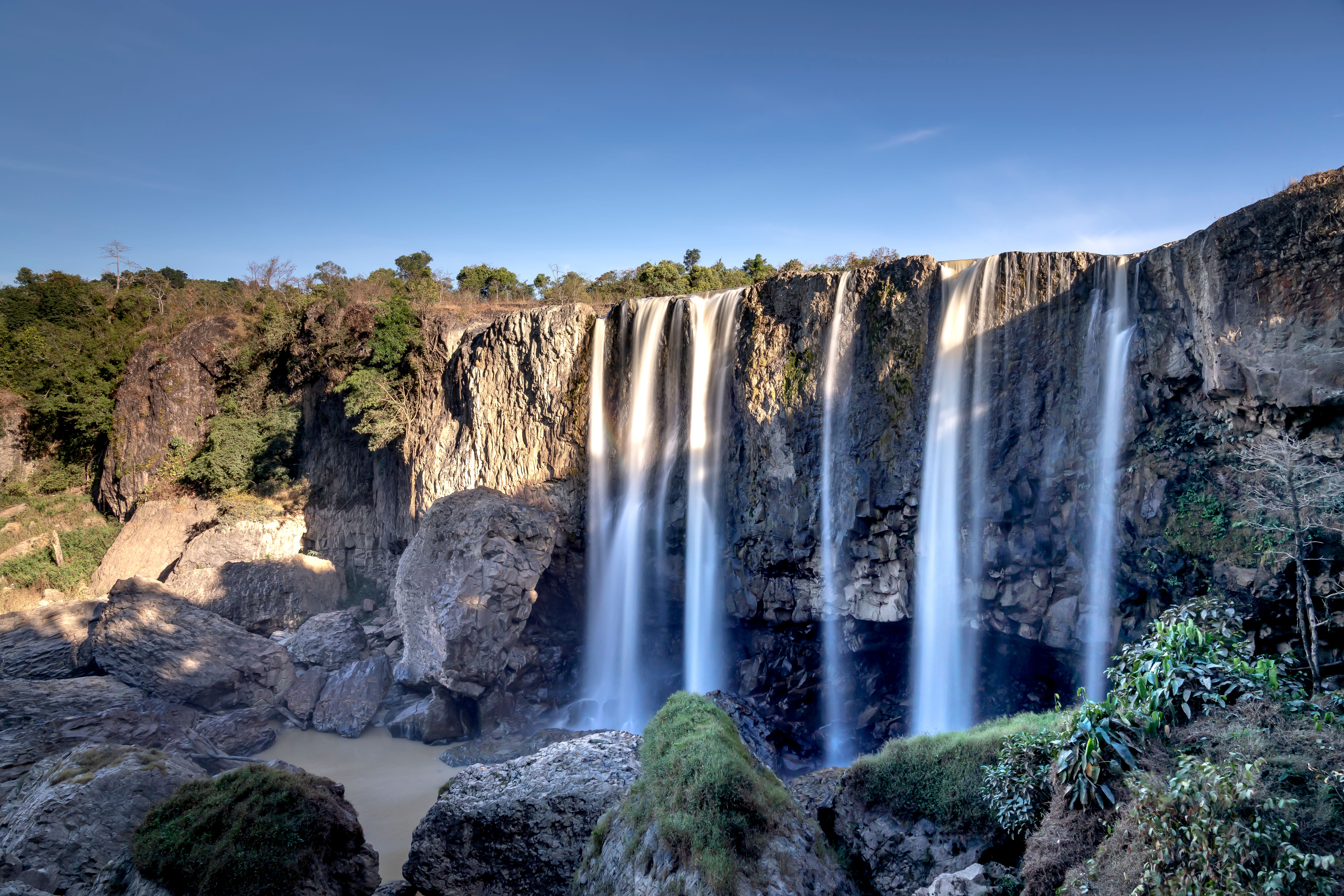 Fast waterfalls on ridge under blue sky · Free Stock Photo
