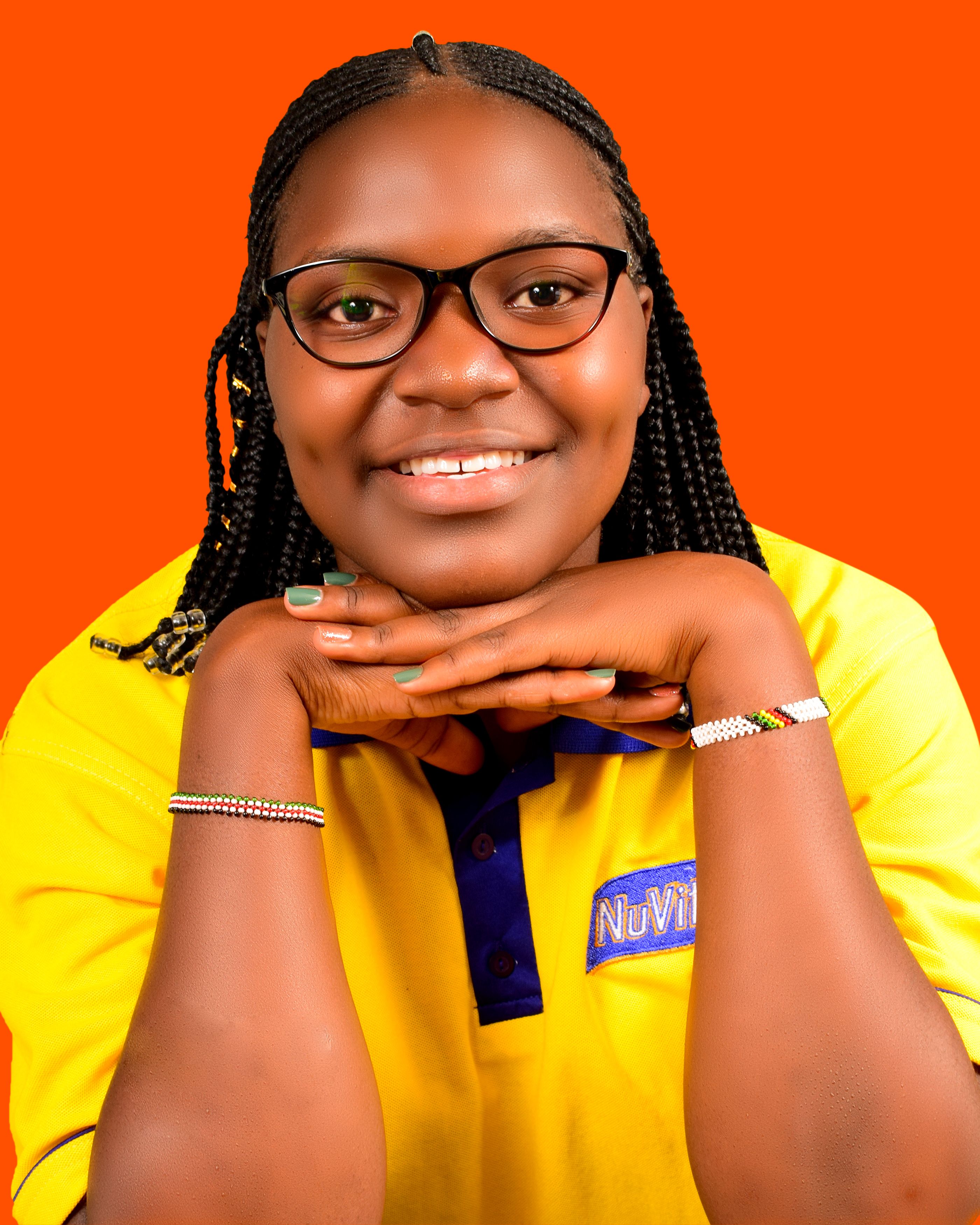 Portrait of a cheerful woman with eyeglasses and a yellow shirt.