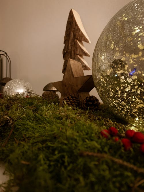 Christmas decoration with wooden toys and baubles arranged with coniferous branches