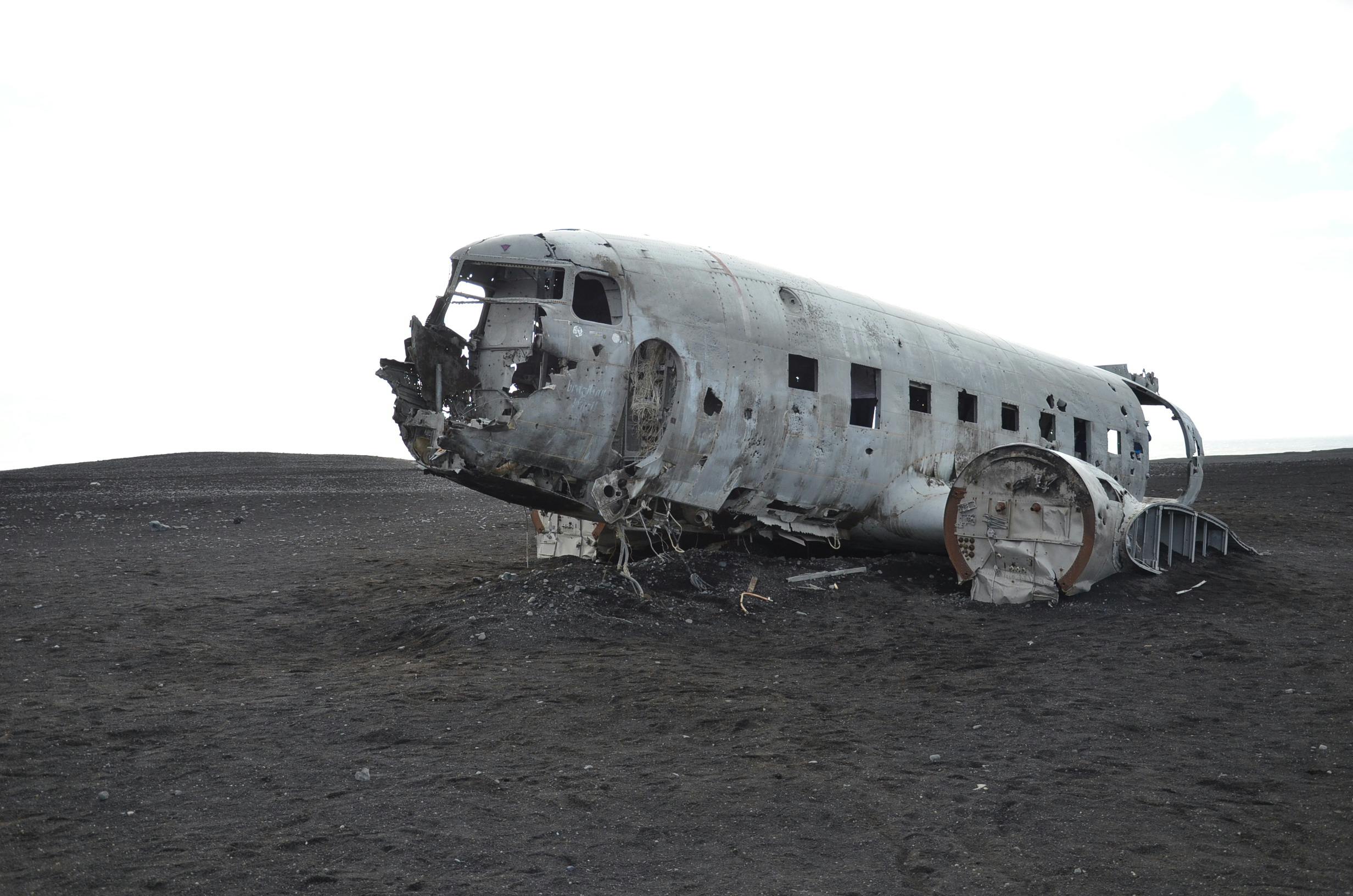 gray airplane on seashore