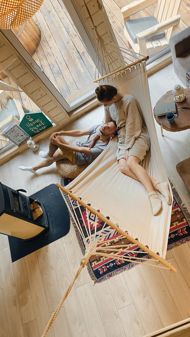 Young Couple Chilling In Spacious House Near Fireplace