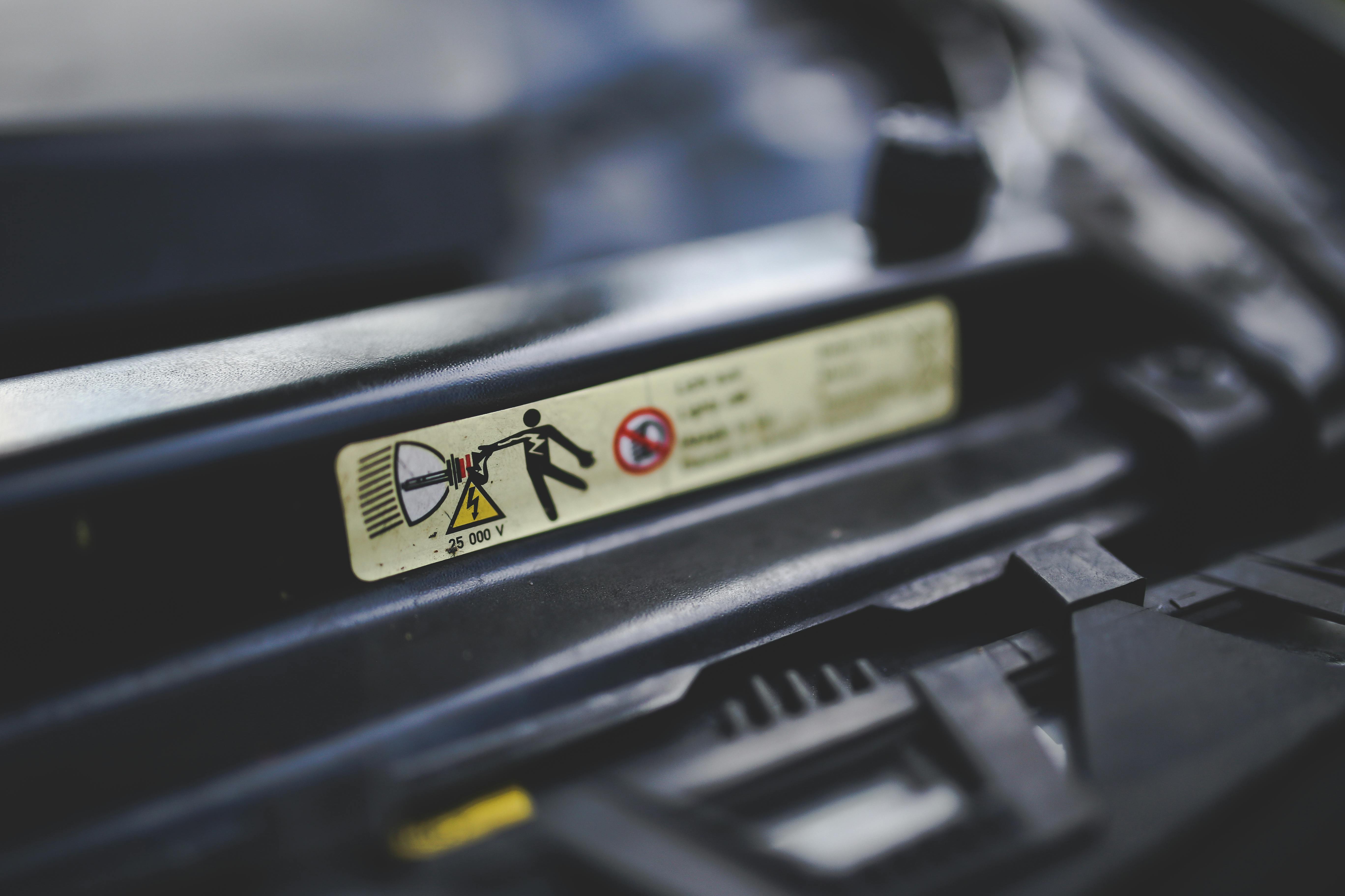 High voltage sign on a car's headlights. Xenon. · Free Stock Photo