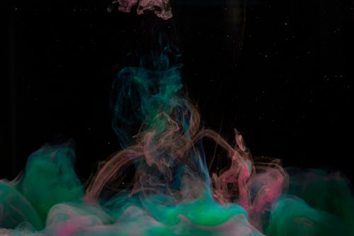 Green and Pink Smoke on Black Background