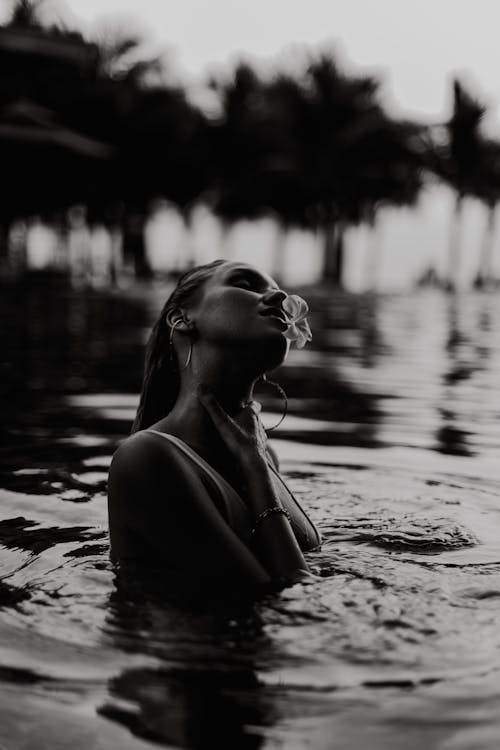 Grayscale Photo of Woman in a Pool