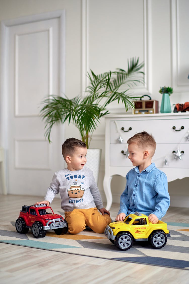 Photograph Of Boys Playing With Toy Cars