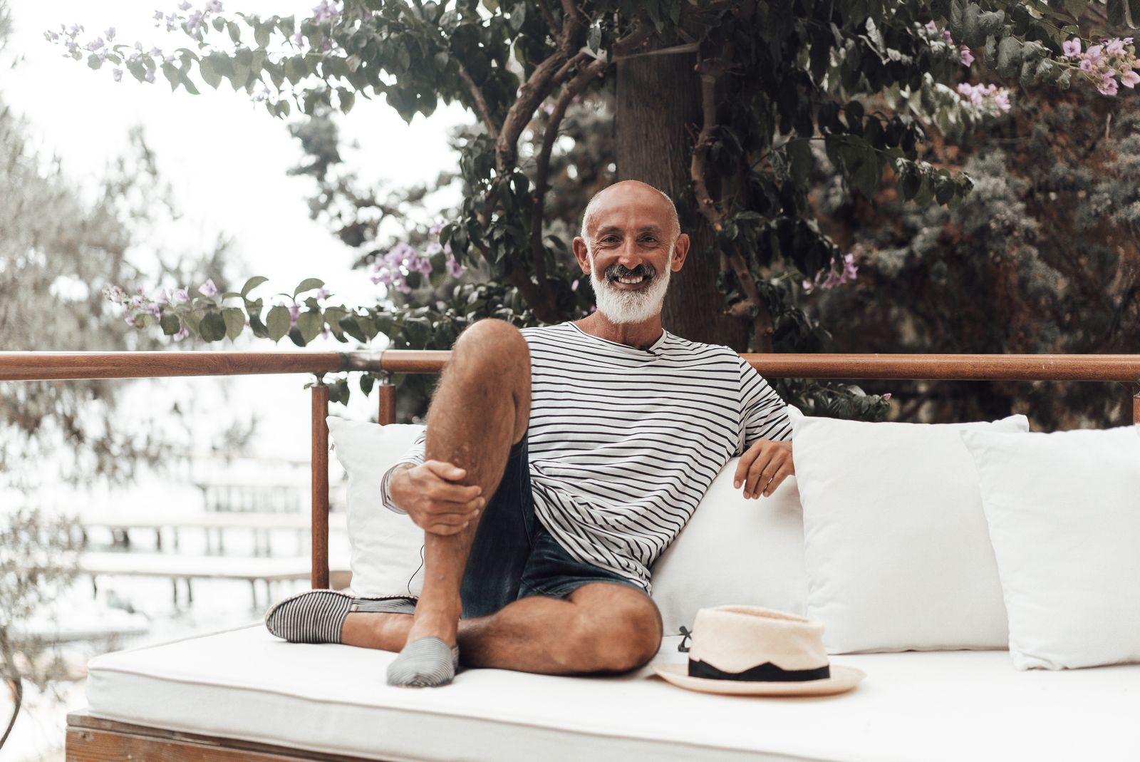 Older man smiling on the couch at home