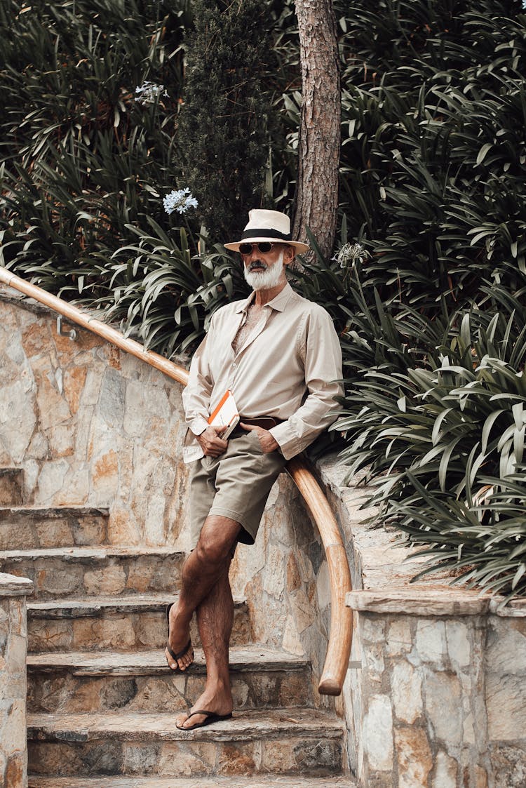 Stylish Mature Man Standing On Park Staircase