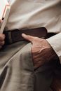 Crop faceless stylish man standing with hand in pocket