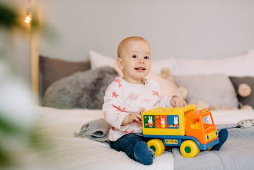 Free Baby Playing with Toy Car  Stock Photo