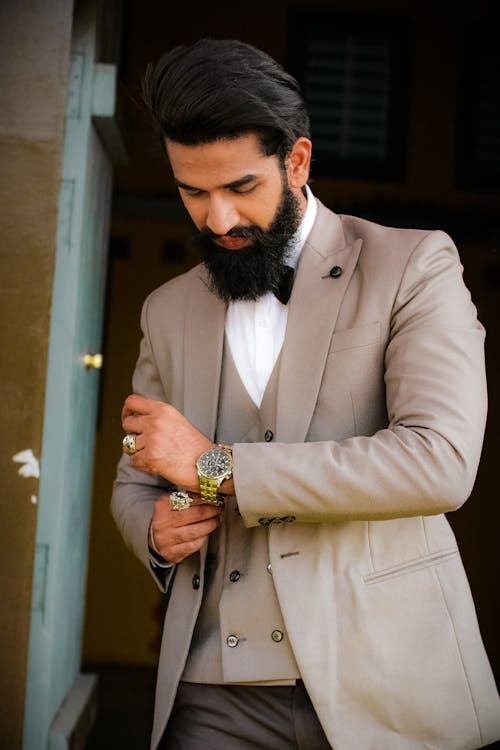 Free Elegantly Dressed Man Putting a Watch on His Wrist  Stock Photo