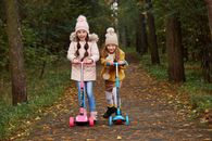 Girl in Pink Jacket Riding Red and Blue Kick Scooter