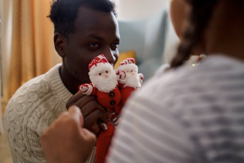 A Man Holding a Red Santa Claus Socks